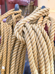 Outdoor, ship and rope in pole at harbor for sailing, transportation and travel at deck. Ocean, marine and sailboat in closeup for luxury, adventure and trip or journey with cruise, cable or navigate