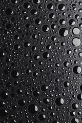 Water droplets forming stunning patterns on dark surface