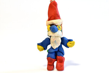 Santa Claus plasticine toy stands on a white background.