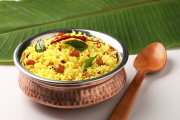  Lemon rice recipe also known as chitrannna or nimmakaya pulihora is a South Indian dish made with rice, tempering spices & curry leaves. Served in a copper bowl with appalam or papad