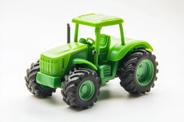 Obraz premium Green plastic tractor toy for kids on a white background