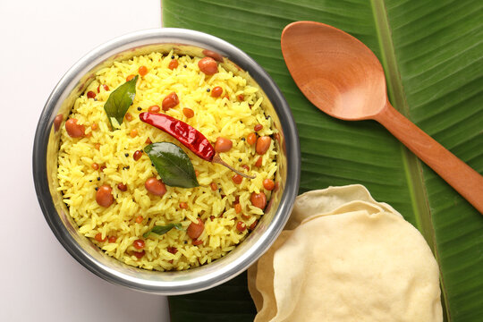  Lemon rice recipe also known as chitrannna or nimmakaya pulihora is a South Indian dish made with rice, tempering spices & curry leaves. Served in a copper bowl with appalam or papad