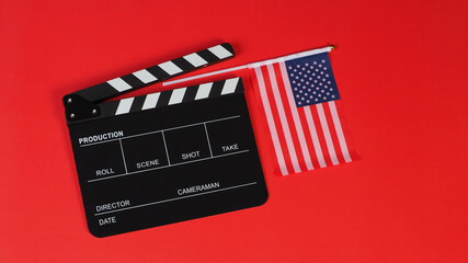 American flag and Clapper board on red background.