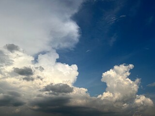 A picturesque sky featuring various cloud formations against a backdrop of deep blue, showcasing the beauty of nature.