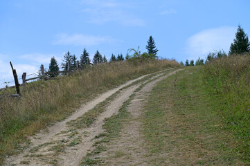 Dirt road on a mountain slope in the Ukrainian Carpathians.