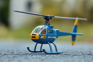 Fototapeta premium tiny blue and yellow toy helicopter for boys
