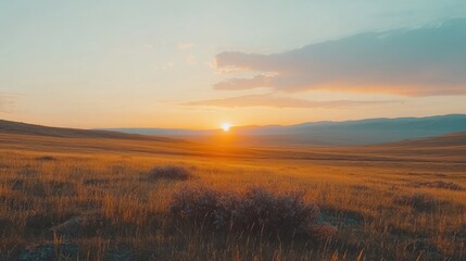 Obraz premium A vibrant sunset casts a warm glow over a vast, rolling plain.