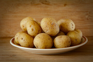 Concept photo of cooked potatoes in front of a brown rustic background