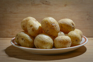 Concept photo of cooked potatoes in front of a brown rustic background