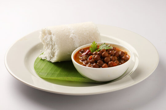 Puttu or Raw rice puttu with chana curry or kadala curry-Kerala special breakfast items made using raw rice flour, an ideal combination with banana