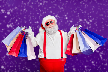 Portrait of his he nice cheery glad cheerful positive bearded thick fat Santa carrying colorful...