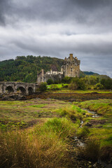 Fototapeta premium Eilean Donan Castle, highlands of scenic Scotland on cloudy day. Portrait orientation.