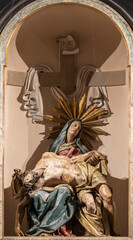 PAVIA, ITALY - SEPTEMBER 8, 2024: The carved byroque polychorme statue of Pieta (Deposition) in the...