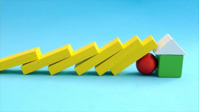 Row of wooden blocks fall and sphere stops them from knocking down house