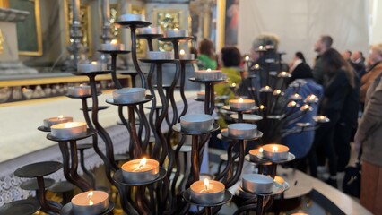 Burning candles in a Catholic church during the Divine Service.