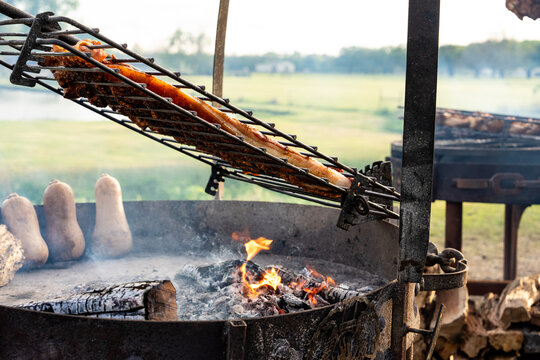 BBQ smoked pork ribs cooking on a grill 