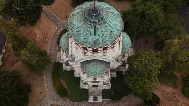 view of chapel-mausoleum "St. George the Victorious" surrounded by lush trees in Pleven, Bulgaria