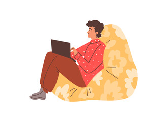 Man sits in a comfortable soft chair with a laptop.