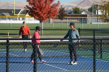 woman playing pickle ball on outdoor pickleball courts