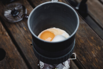 Egg cooking in a camping gas cooker