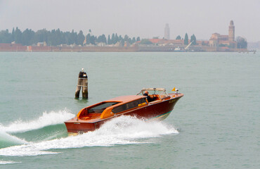 Water Taxi Cruising Through Venetian Lagoon