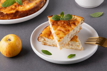 Delicious homemade apple pie served with coffee and garnished with mint leaves on a cozy kitchen table