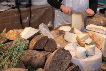 Traditional italian mature cheese Pecorino at the market stall. Close up.