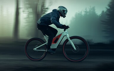 Naklejka premium Electric Bike Rider in Misty Forest: A solitary cyclist races through a misty forest on an electric bike, capturing the thrill of speed and the tranquility of nature. 