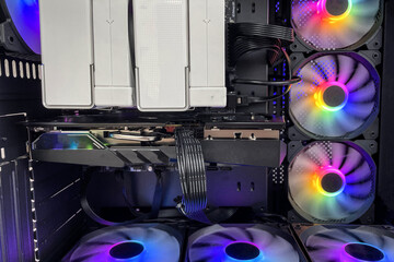 Close-up and inside Desktop PC Gaming and Cooling Fan CPU with multicolored LED RGB light show status on working mode, interior PC case technology background