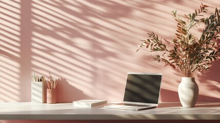 Fototapeta premium Minimalist Workspace Aesthetic, featuring a pastel pink backdrop, a sleek laptop, organized notebooks, and chic stationery for a modern, serene environment