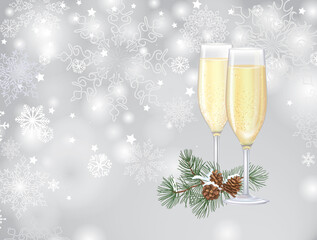 Two flute glasses filled with sparkling champagne over winter nnoel snowy blurred background.Merry Christmas greeting card with snowflakes and conifeerous branch with cone in snow