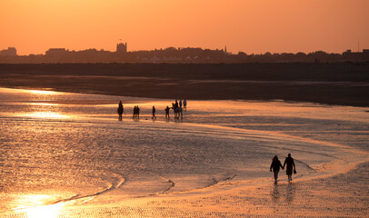 Beach at south end of Hayling island is turned golden by sunset