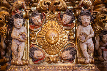 A church ornament with a sun and angels