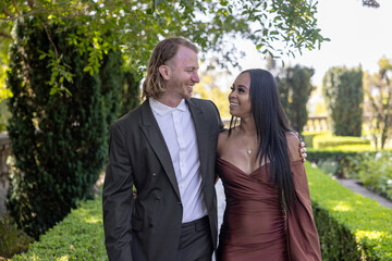 A stunning engagement photoshoot beautifully capturing a mixed couple immersed in a romantic outdoor setting, showcasing the depth of their love and unwavering commitment to one another