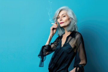 Fototapeta premium Stylish mature woman smoking empowerment of older adults.