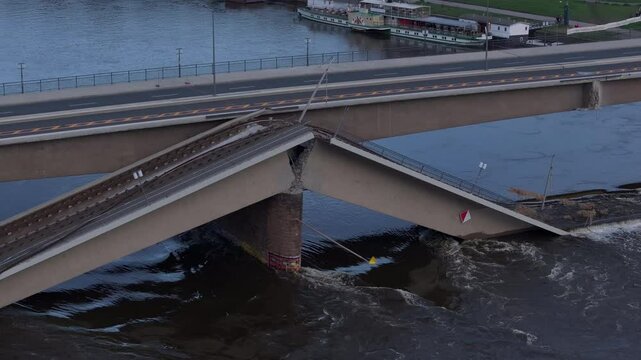 Aerial view of the carola bridge in Dresden after the disaster of its collapse on the Elbe River. Trams were forced to stop running over it