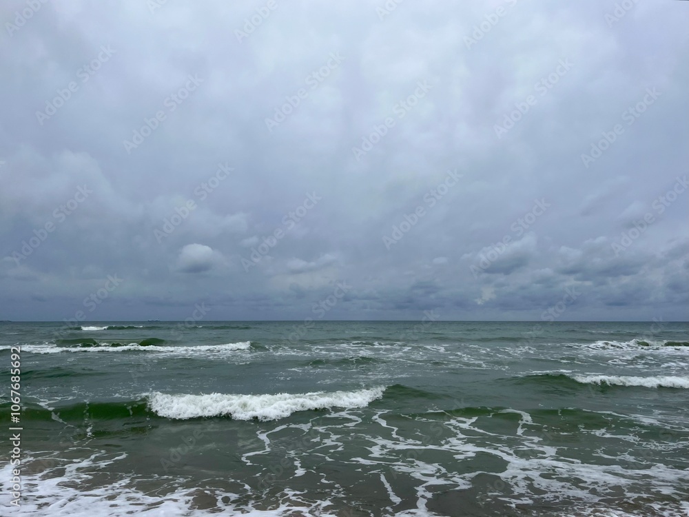 Canvas Prints cloudy grey seascape, waved sea horizon, windy at the sea, empty beach