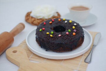 Chocolate cake on white plate with bamboo mat 