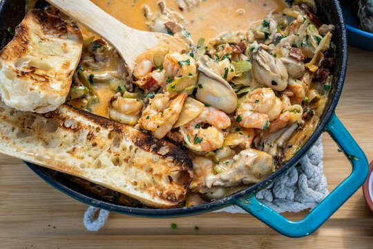 Seafood stew being cooked on a grill 