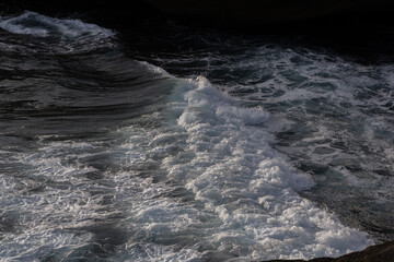 A dynamic shot of sea waves crashing against the shore, capturing the raw energy and movement of the ocean. Perfect for conveying power, nature, and the beauty of the sea in action.