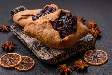Sweet rye pies with cherries and chocolate