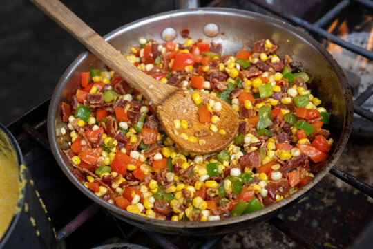 Bacon, corn and green and red peppers in a skillet 
