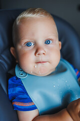 A little boy learns to eat with a fork. Baby food. The child learns to eat independently.