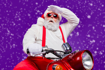 Photo of santa claus man riding newyear party by bike looking far away on distance not believe road...