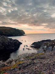 Kayakers Calf of man island Isle of Man cliffs, sunset over the sea