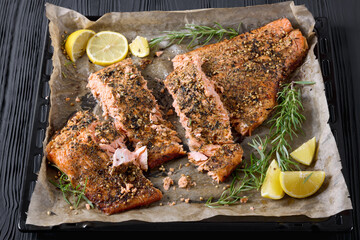 baked salmon fillet on baking tray, top view