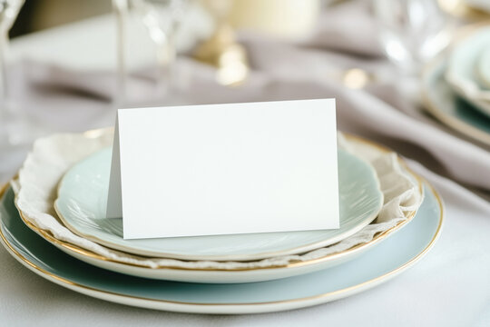 Blank mock ap card on ceramic plates on a table with a linen tablecloth