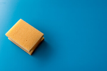 one dish yellow sponge on the blue background.