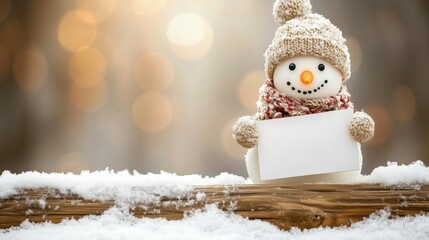 Adorable snowman in winter attire holding a blank sign, surrounded by snow with warm bokeh lights.