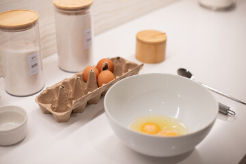 ingredients for cooking, breakfast, step-by-step cooking, eggs, plate, whisk for whipping, flour, baking ingredients on the kitchen table, ingredients for pancake, crepes 